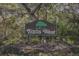 Trails West neighborhood sign with tree, shrubs and mulch at 510 Sandy Bluff Trl, Deland, FL 32724