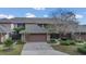 Townhome with an attached two-car garage and well-manicured landscaping at 510 Sandy Bluff Trl, Deland, FL 32724