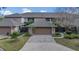Townhome with an attached two-car garage and well-manicured landscaping at 510 Sandy Bluff Trl, Deland, FL 32724