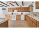 Well-lit kitchen with wooden cabinets, white appliances, and ample counter space at 510 Sandy Bluff Trl, Deland, FL 32724