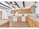 Well-equipped kitchen with wooden cabinets, white appliances, and a functional layout at 510 Sandy Bluff Trl, Deland, FL 32724