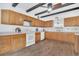 Bright kitchen with wooden cabinets, white appliances, and modern countertops at 510 Sandy Bluff Trl, Deland, FL 32724
