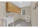 Functional laundry room featuring a utility sink, storage cabinets, and a practical layout at 510 Sandy Bluff Trl, Deland, FL 32724