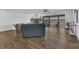 Living room with hardwood flooring, fireplace, and views of a lake from screened-in porch at 510 Sandy Bluff Trl, Deland, FL 32724