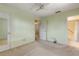 Spacious bedroom with carpeted floor and view into updated bathroom at 564 Cambridge Cir, South Daytona, FL 32119