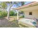 Backyard patio with a view of the shed and lush greenery at 564 Cambridge Cir, South Daytona, FL 32119