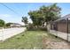 Wide-open backyard featuring a white fence and the back of a screened-in porch at 583 Wilburton Dr, Deltona, FL 32738