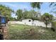 Green, fenced backyard with a shed and connection to the home's screened-in porch at 583 Wilburton Dr, Deltona, FL 32738