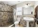 Bathroom with a tile shower, vanity sink, patterned walls, and a shower curtain at 583 Wilburton Dr, Deltona, FL 32738