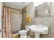 Neutral bathroom featuring a large sink, tiled walk-in shower with glass and a decorative shower curtain at 583 Wilburton Dr, Deltona, FL 32738