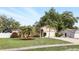 Lovely single-story home featuring a well-manicured lawn, mature landscaping, and an attached two-car garage at 583 Wilburton Dr, Deltona, FL 32738
