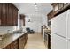 Modern kitchen featuring granite countertops, stainless steel appliances, and rich wood cabinetry for a luxurious feel at 583 Wilburton Dr, Deltona, FL 32738