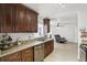 The kitchen features granite countertops, dark wood cabinetry, and stainless steel appliances at 583 Wilburton Dr, Deltona, FL 32738