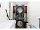 Bright laundry room featuring a stackable washer and dryer, shelf and some storage solutions at 583 Wilburton Dr, Deltona, FL 32738
