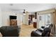 An open concept living area and kitchen with tile flooring and a ceiling fan at 583 Wilburton Dr, Deltona, FL 32738