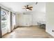 Bright and airy living room featuring large windows, tile floors, and a unique ceiling fan with decorative blades at 583 Wilburton Dr, Deltona, FL 32738
