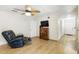 A bright living room with tile flooring, a ceiling fan, and a vintage wood storage cabinet at 583 Wilburton Dr, Deltona, FL 32738