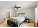 A bright main bedroom with tile flooring, a ceiling fan, and a dark wood dresser at 583 Wilburton Dr, Deltona, FL 32738