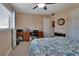 Spacious bedroom featuring a desk area and comfortable bed with patterned quilt at 600 N Boundary Ave # 109C, Deland, FL 32720