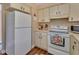 Bright kitchen featuring white appliances, cabinets, and wood-look flooring at 600 N Boundary Ave # 109C, Deland, FL 32720