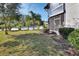 Lush backyard with views of the community pool and lounge chairs at 600 N Boundary Ave # 114B, Deland, FL 32720