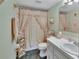 Cozy bathroom with sage walls, decorative shower curtain, and vanity sink at 600 N Boundary Ave # 114B, Deland, FL 32720
