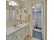 Well-maintained bathroom featuring a pristine vanity, a mirrored cabinet, and a glass-enclosed shower, offering a clean and modern feel at 600 N Boundary Ave # 114B, Deland, FL 32720