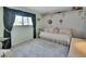 Comfortable secondary bedroom featuring a cozy daybed, large window, and soft decor, creating a peaceful and inviting space at 600 N Boundary Ave # 114B, Deland, FL 32720
