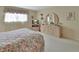 Bright bedroom showcasing a dresser, tv and closet with soft neutral colors, and large windows providing natural lighting at 600 N Boundary Ave # 114B, Deland, FL 32720