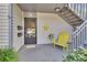 Inviting condo entrance featuring a staircase and bright yellow chair at 600 N Boundary Ave # 114B, Deland, FL 32720