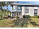 Charming two-story condo building showcasing its well-maintained landscaping at 600 N Boundary Ave # 114B, Deland, FL 32720