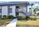 Charming condo featuring well-maintained landscaping and a welcoming entrance with stairs to the upper unit at 600 N Boundary Ave # 114B, Deland, FL 32720