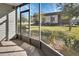 Relaxing enclosed lanai providing serene views of the grassy yard at 600 N Boundary Ave # 114B, Deland, FL 32720