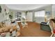 Comfortable living room with bright lighting and seating. Large sliding door offers views of outdoors at 600 N Boundary Ave # 114B, Deland, FL 32720