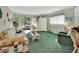 Comfortable living room featuring a floral sofa and a large window, allowing for ample natural light at 600 N Boundary Ave # 114B, Deland, FL 32720