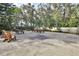 Outdoor recreational space featuring picnic tables and seating under a canopy of mature trees for relaxation and enjoyment at 600 N Boundary Ave # 114B, Deland, FL 32720