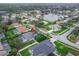 Aerial view of a neighborhood featuring a community pond and lush landscaping at 6150 Half Moon Dr, Port Orange, FL 32127