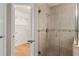 Bathroom shower with glass door and a view to a walk-in closet with shelving at 6150 Half Moon Dr, Port Orange, FL 32127