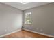 Bedroom with wood floor, bright lighting and large window with backyard view at 6150 Half Moon Dr, Port Orange, FL 32127
