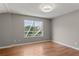 Bedroom with wood floors, bright lighting and large window with backyard view at 6150 Half Moon Dr, Port Orange, FL 32127