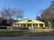 Community center featuring a yellow building and green landscaping at 6150 Half Moon Dr, Port Orange, FL 32127