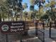 Seemor Memorial Dog Park entrance, featuring a gated entry and a sign in a wooded area at 6150 Half Moon Dr, Port Orange, FL 32127