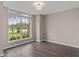 Neutral empty room showcases dark floors, large window with bright light, and neutral colored walls at 6150 Half Moon Dr, Port Orange, FL 32127