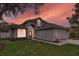 Charming home boasts professional landscaping, a well-kept lawn, and a spacious two-car garage at 6150 Half Moon Dr, Port Orange, FL 32127