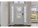 Elegant front door with decorative glass panels and sidelights, enhancing the entryway's appeal at 6150 Half Moon Dr, Port Orange, FL 32127