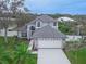 Stately two-story home boasting a well-manicured lawn, complemented by a two-car garage and mature landscaping at 6150 Half Moon Dr, Port Orange, FL 32127
