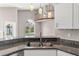 Spacious kitchen with granite countertops, stainless steel sink, and an open view of the living area at 6150 Half Moon Dr, Port Orange, FL 32127