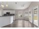 Bright kitchen with white cabinets, granite countertops, stainless steel appliances, and an adjacent dining area at 6150 Half Moon Dr, Port Orange, FL 32127