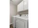 Laundry room featuring a white washer and dryer with overhead cabinets for storage at 6150 Half Moon Dr, Port Orange, FL 32127