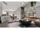 Bright, modern living room with vaulted ceilings, stylish furniture, and views of the outdoors at 6150 Half Moon Dr, Port Orange, FL 32127